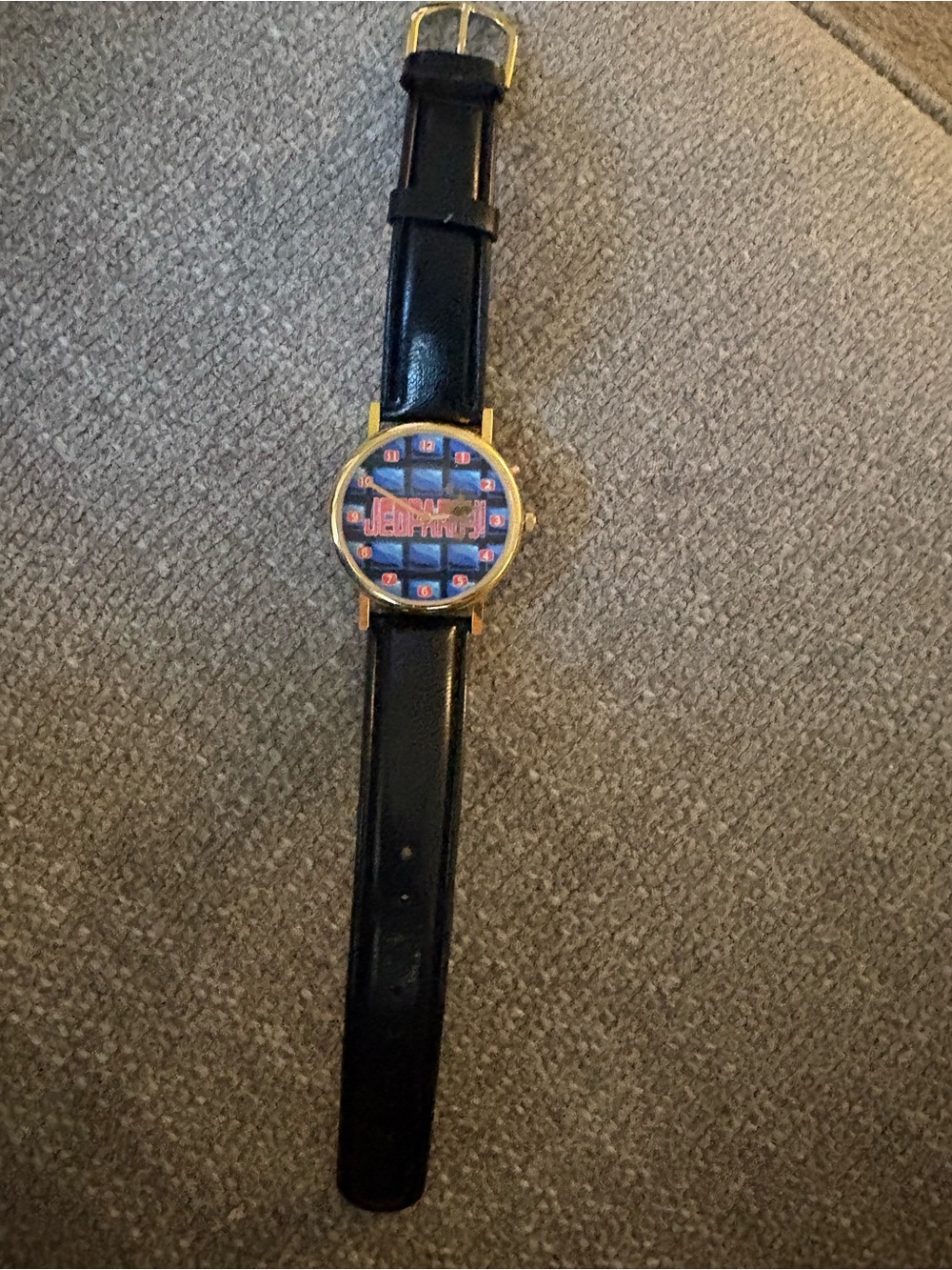 Jeopardy Black Leather Strap Wristwatch with Gold Case and Patterned Dial